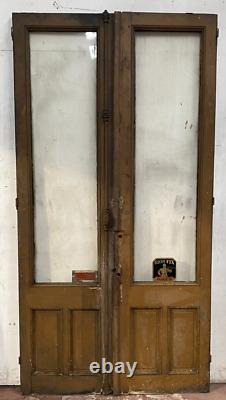Double portes de passage en verre et sapin patiné XX siècle