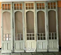 Suite de cinq portes de passage en bois patiné XX siècle